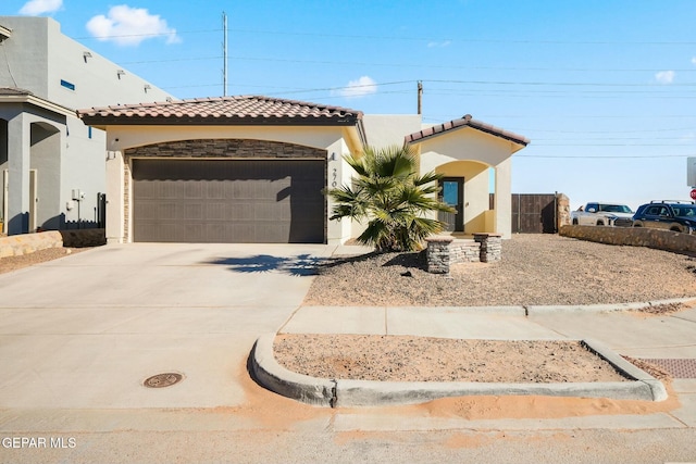 mediterranean / spanish-style home with a garage