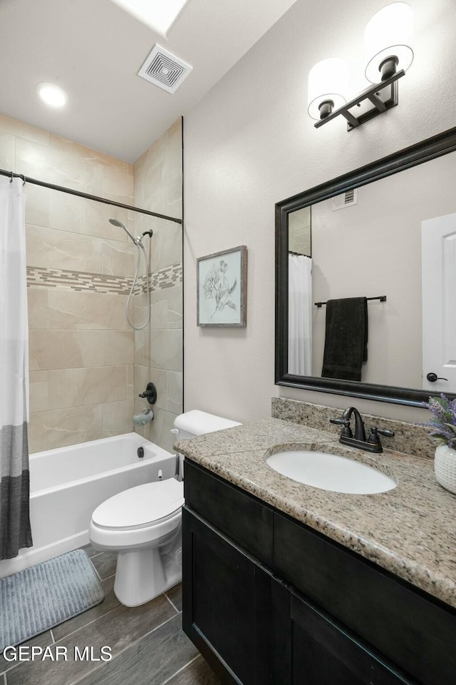 full bathroom with vanity, toilet, and shower / bath combo with shower curtain