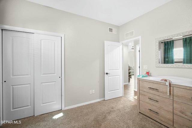 carpeted bedroom featuring a closet