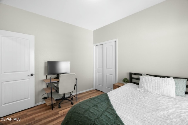 bedroom with hardwood / wood-style floors and a closet