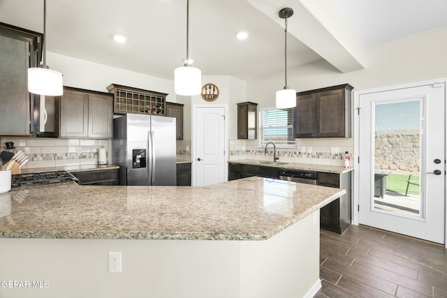 kitchen with pendant lighting, dark brown cabinets, decorative backsplash, and appliances with stainless steel finishes