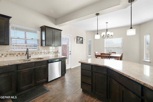 kitchen with decorative backsplash, sink, decorative light fixtures, dishwasher, and a chandelier