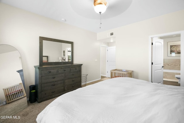 carpeted bedroom featuring ceiling fan and ensuite bath