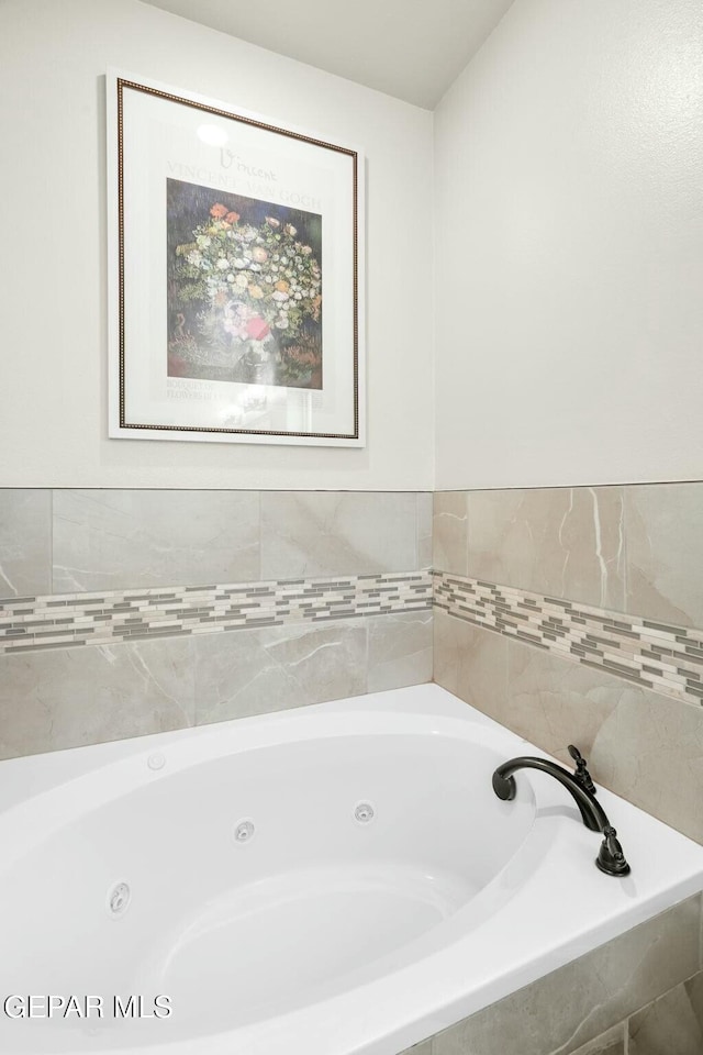 bathroom featuring a relaxing tiled tub