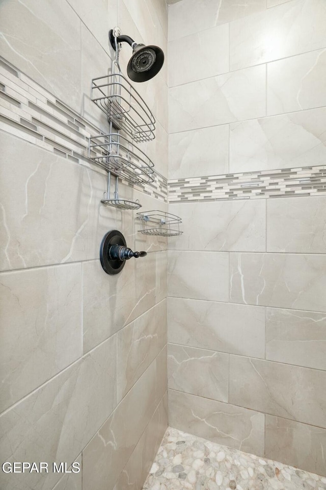 bathroom with tiled shower