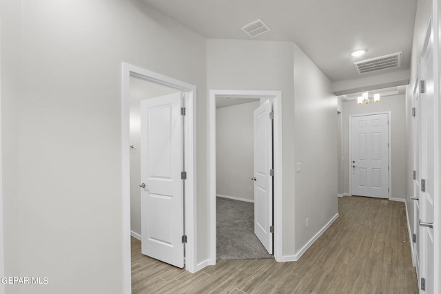 hall with light hardwood / wood-style floors