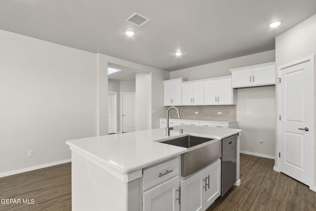 kitchen featuring backsplash, a center island with sink, sink, stainless steel dishwasher, and white cabinetry