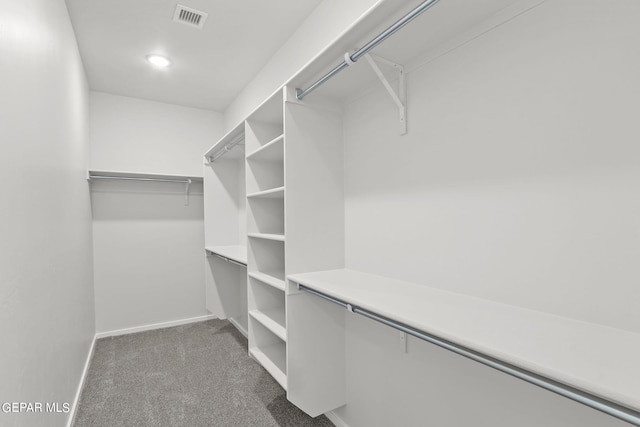 spacious closet featuring dark carpet