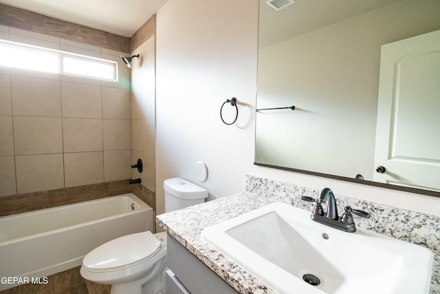 full bathroom with vanity, toilet, and tiled shower / bath