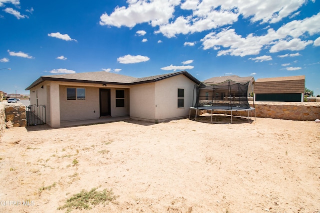 back of property with a trampoline