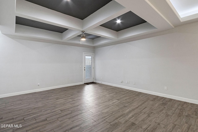 empty room featuring hardwood / wood-style floors and coffered ceiling