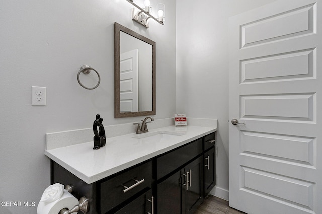 bathroom with vanity and wood-type flooring