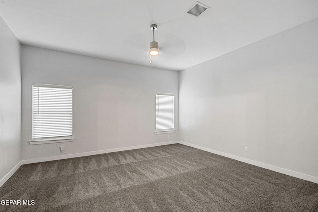 empty room with carpet, ceiling fan, and a healthy amount of sunlight