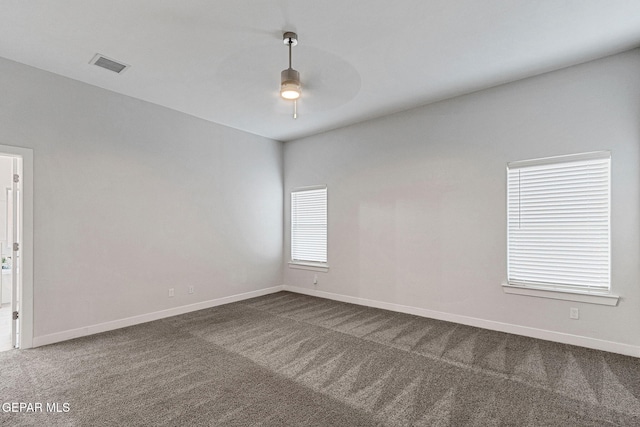 carpeted spare room with ceiling fan