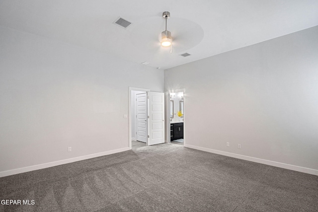 unfurnished bedroom featuring ceiling fan, carpet floors, and a towering ceiling