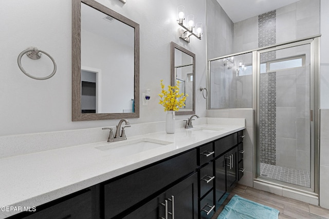 bathroom featuring hardwood / wood-style floors, vanity, and walk in shower