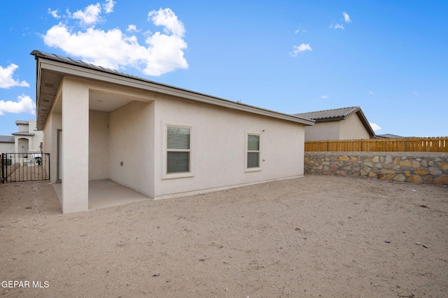 back of house with a patio