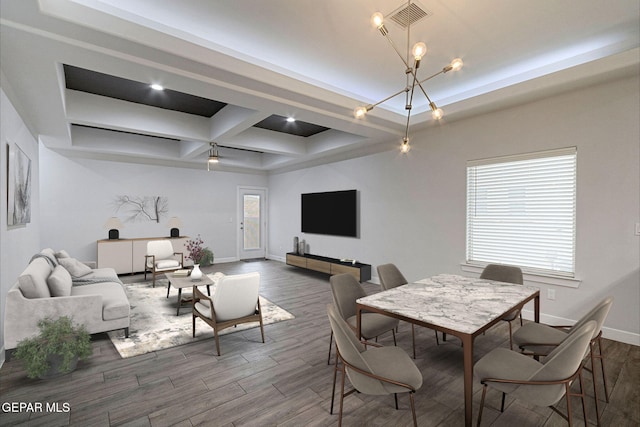 dining room featuring a tray ceiling, a wealth of natural light, coffered ceiling, and an inviting chandelier