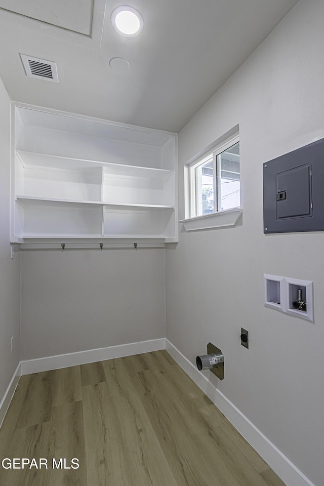 laundry area featuring hookup for an electric dryer, washer hookup, electric panel, and wood-type flooring