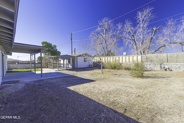 view of yard featuring a patio area and an outdoor structure