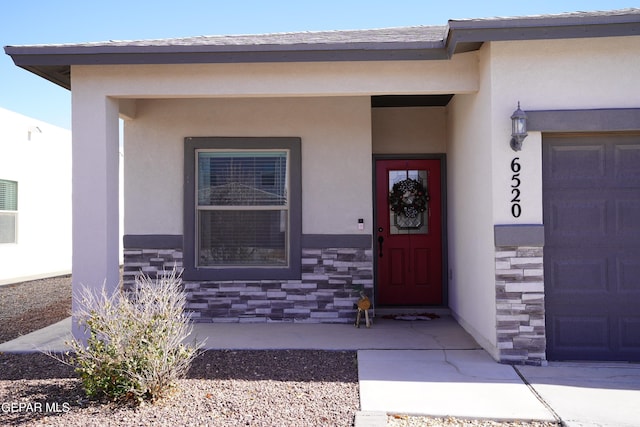 doorway to property with a porch and a garage