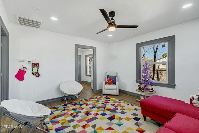 sitting room featuring dark hardwood / wood-style flooring and ceiling fan