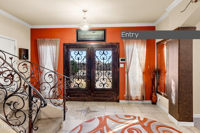 foyer featuring light tile patterned floors, crown molding, and french doors