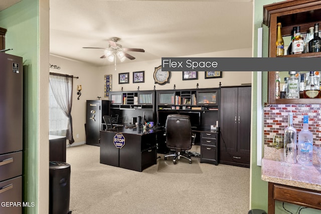 carpeted home office with ceiling fan