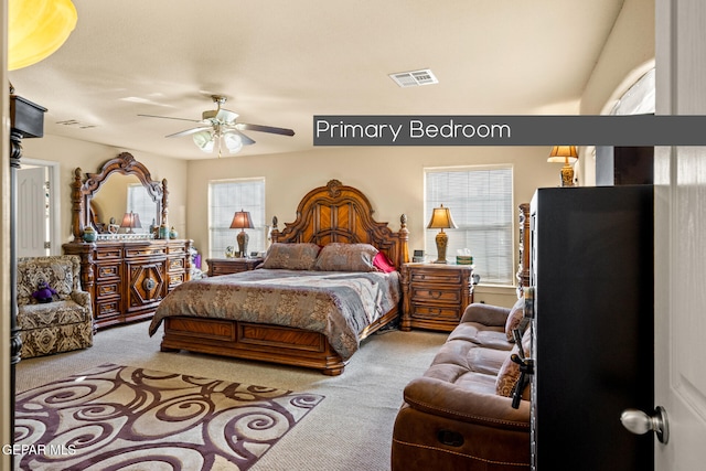 carpeted bedroom with ceiling fan and multiple windows