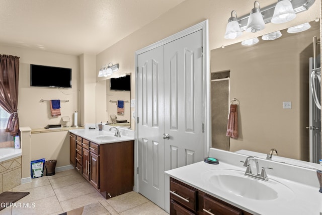 bathroom with tile patterned floors, vanity, and independent shower and bath