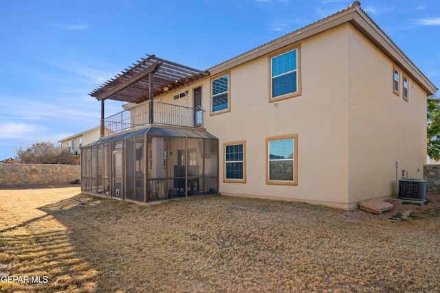 back of property featuring a pergola, a balcony, and central AC unit