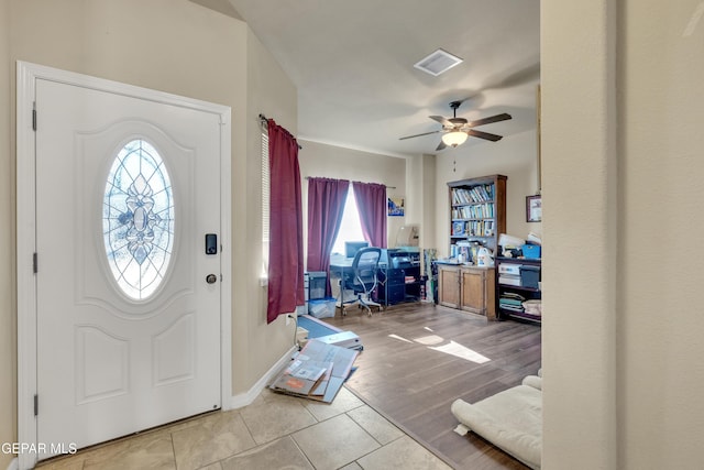 tiled foyer with ceiling fan and a wealth of natural light