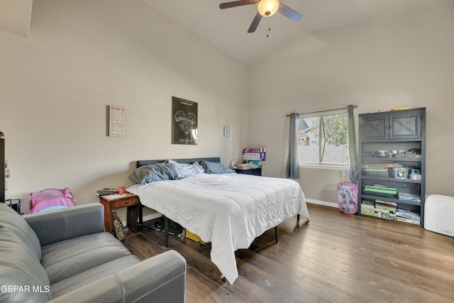 bedroom with ceiling fan, hardwood / wood-style floors, and lofted ceiling