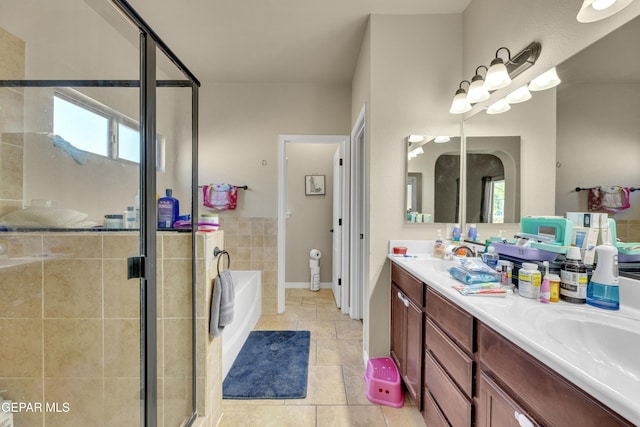 bathroom featuring separate shower and tub, a healthy amount of sunlight, vanity, and tile patterned floors