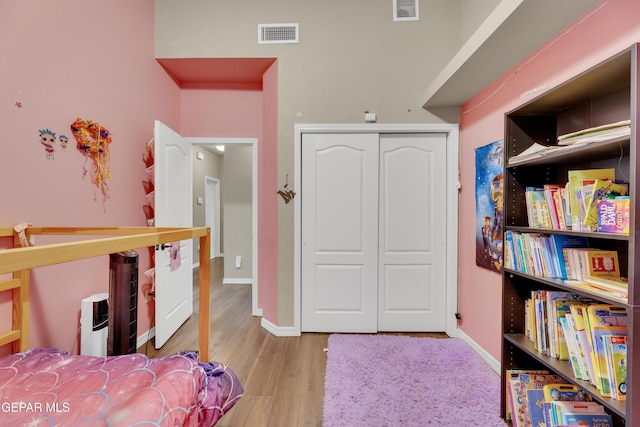 bedroom with a closet and light hardwood / wood-style flooring