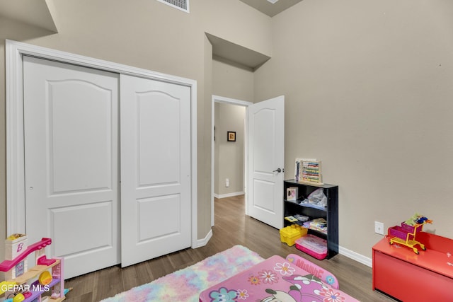 bedroom with a closet and hardwood / wood-style flooring