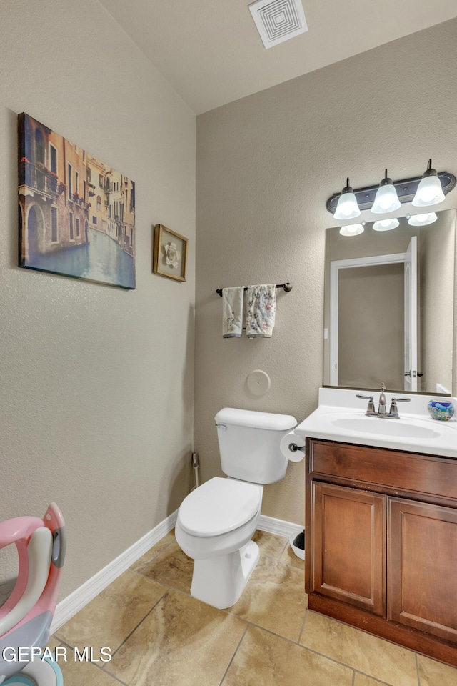 bathroom with tile patterned floors, vanity, and toilet