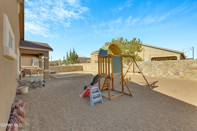 view of jungle gym featuring a patio