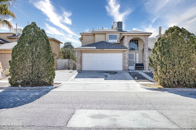 front of property featuring cooling unit and a garage