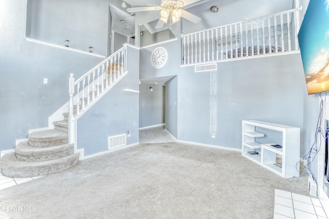 living room featuring visible vents, ceiling fan, and carpet flooring