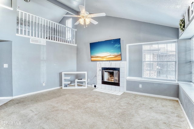 unfurnished living room with carpet, a fireplace, baseboards, and ceiling fan