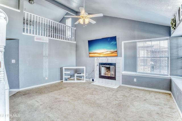 unfurnished living room featuring carpet, visible vents, a ceiling fan, a tile fireplace, and baseboards