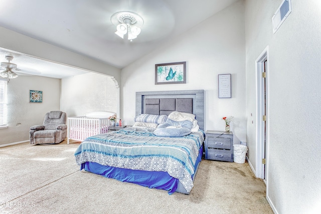 carpeted bedroom featuring lofted ceiling, visible vents, a textured wall, and baseboards