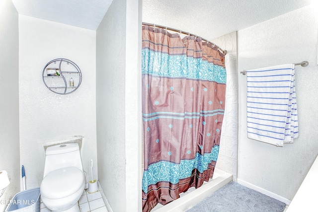 bathroom with a textured ceiling, a textured wall, curtained shower, and baseboards