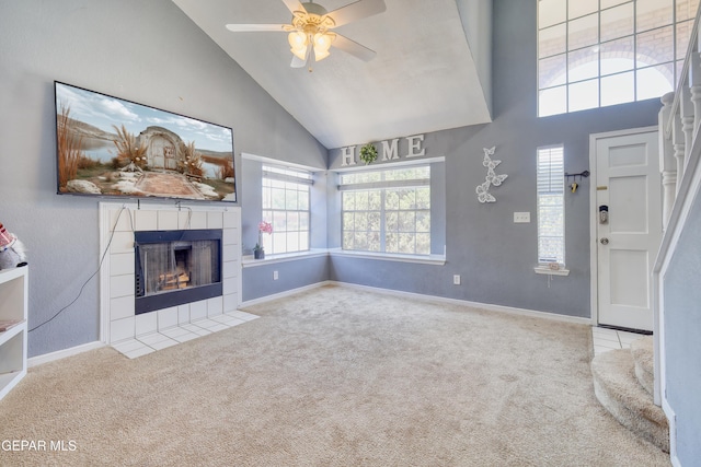 11948 Mcauliffe Dr, El Paso, TX 79936 - unfurnished living room featuring high vaulted ceiling, a tile fireplace, carpet floors, ceiling fan, and baseboards
