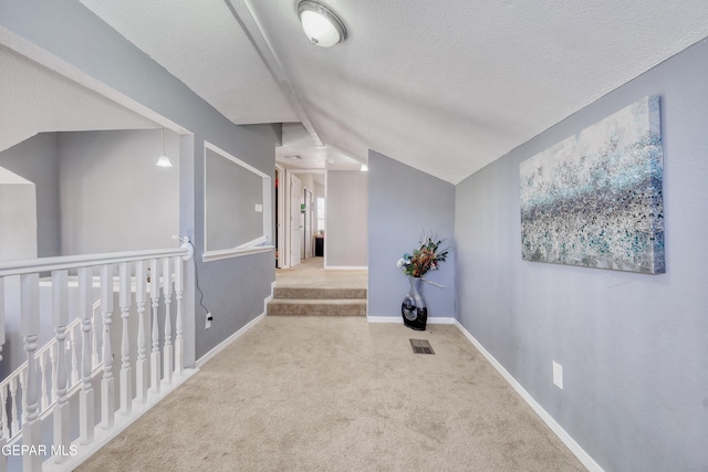 11948 Mcauliffe Dr, El Paso, TX 79936 - hallway with carpet flooring, a textured ceiling, baseboards, and lofted ceiling