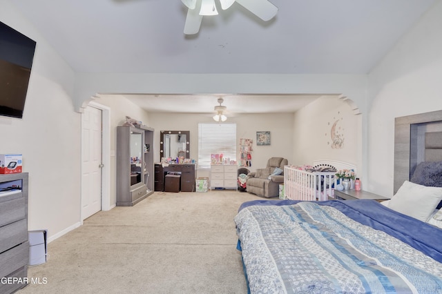 11948 Mcauliffe Dr, El Paso, TX 79936 - bedroom with light colored carpet, ceiling fan, and baseboards