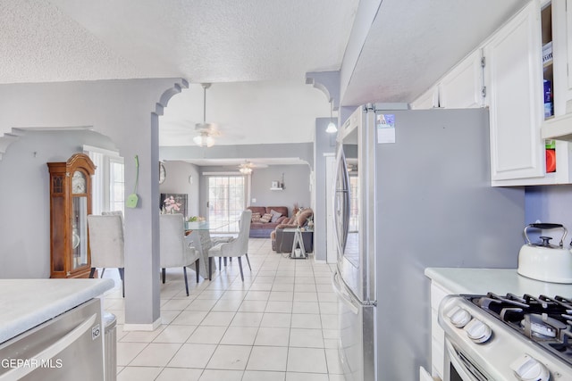 11948 Mcauliffe Dr, El Paso, TX 79936 - kitchen with a textured ceiling, stainless steel appliances, white cabinetry, a ceiling fan, and light countertops