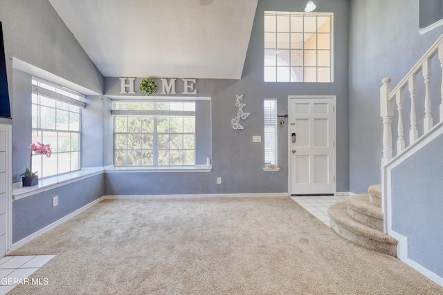 11948 Mcauliffe Dr, El Paso, TX 79936 - carpeted foyer entrance featuring stairway, high vaulted ceiling, and baseboards