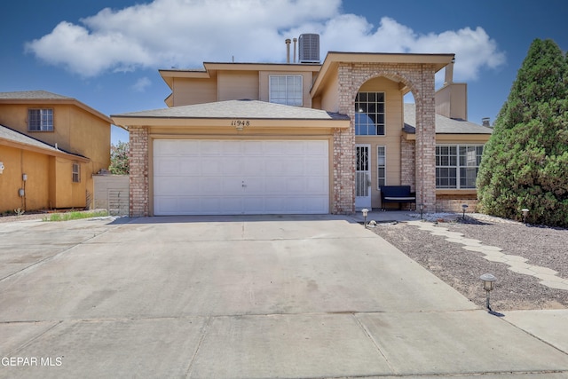 11948 Mcauliffe Dr, El Paso, TX 79936 - traditional-style house with brick siding, a garage, concrete driveway, and central AC